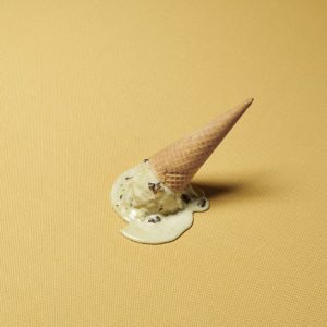 Ice cream melting on gold fabric.