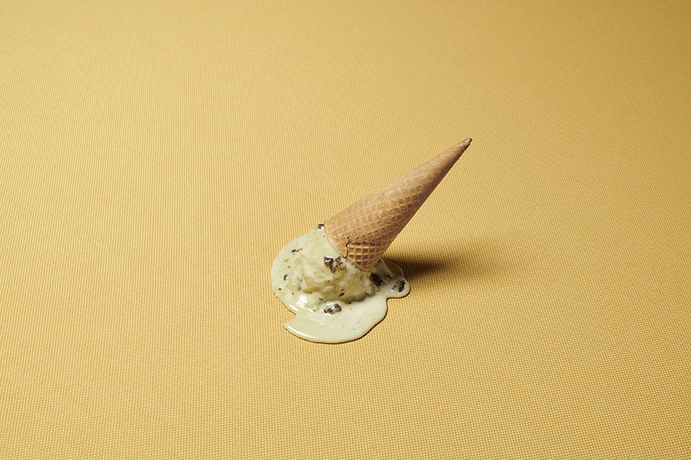 Ice cream melting on gold fabric.