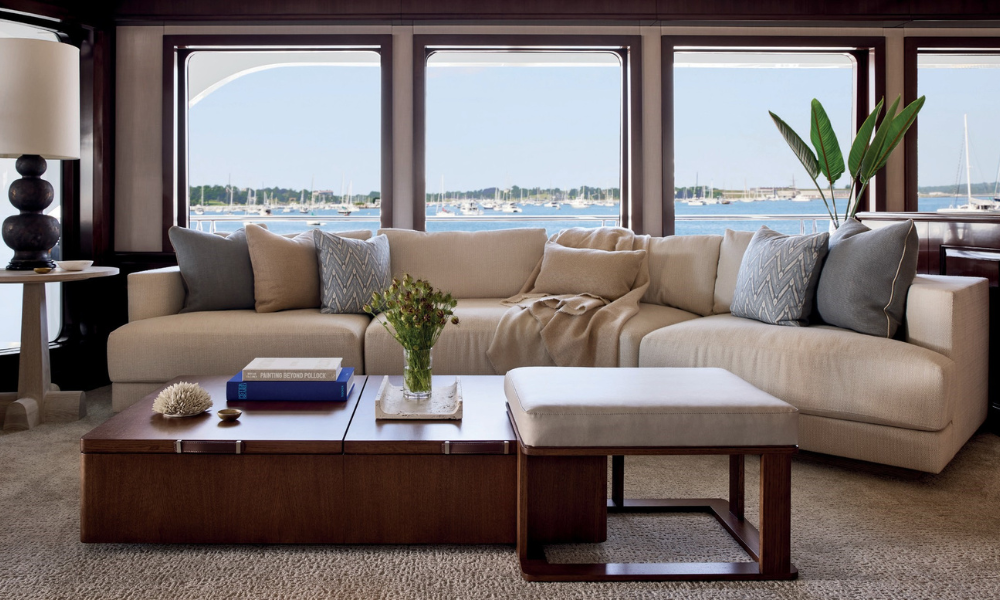 Left to Right: A tailored banquette is upholstered in Perennials’s Raffia Chalk. Sutherland’s Neoclassic folding chairs surround a custom dining table. Right: In the lounge, chairs are covered in Snazzy White Sands.